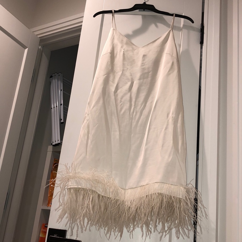 Satin white dress with feathered bottom